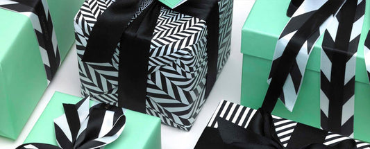 Blue, Black and White gift wrapped Boxes. Claridges and Holland Street Branding