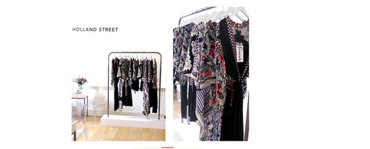 Rails of clothes at LFW with Fewick logo on kaftans