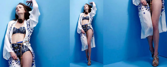 Model Anais Garner standing against blue wall wearing silk kimono