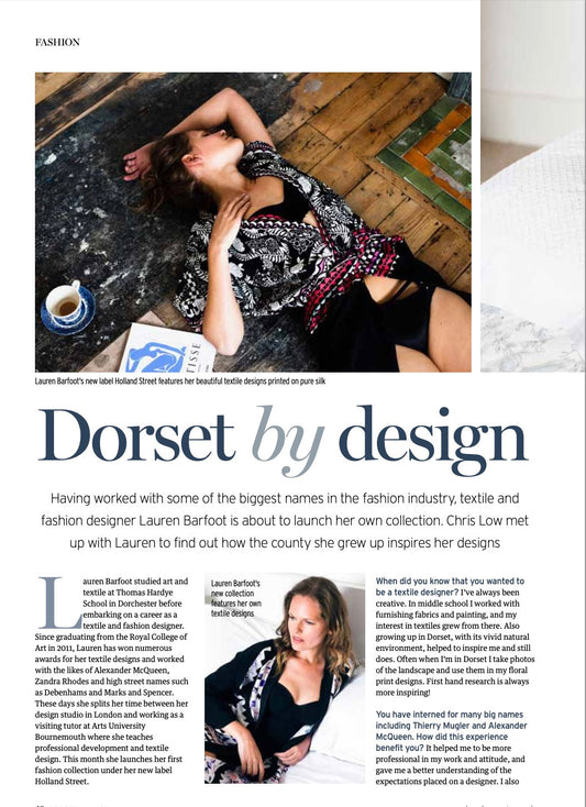 Lauren Barfoot in her design studio, surrounded by printed silk kaftans from her Holland Street collection—luxury loungewear inspired by Dorset’s natural landscape and crafted with sustainable British textiles.