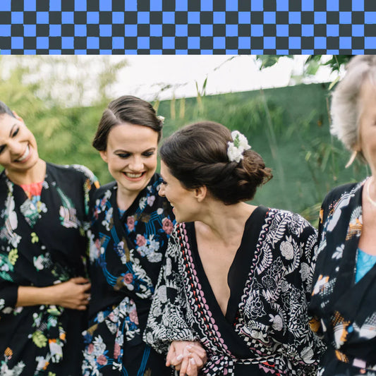Client wearing a printed silk kaftan from Holland Street, smiling at an outdoor weddingevent