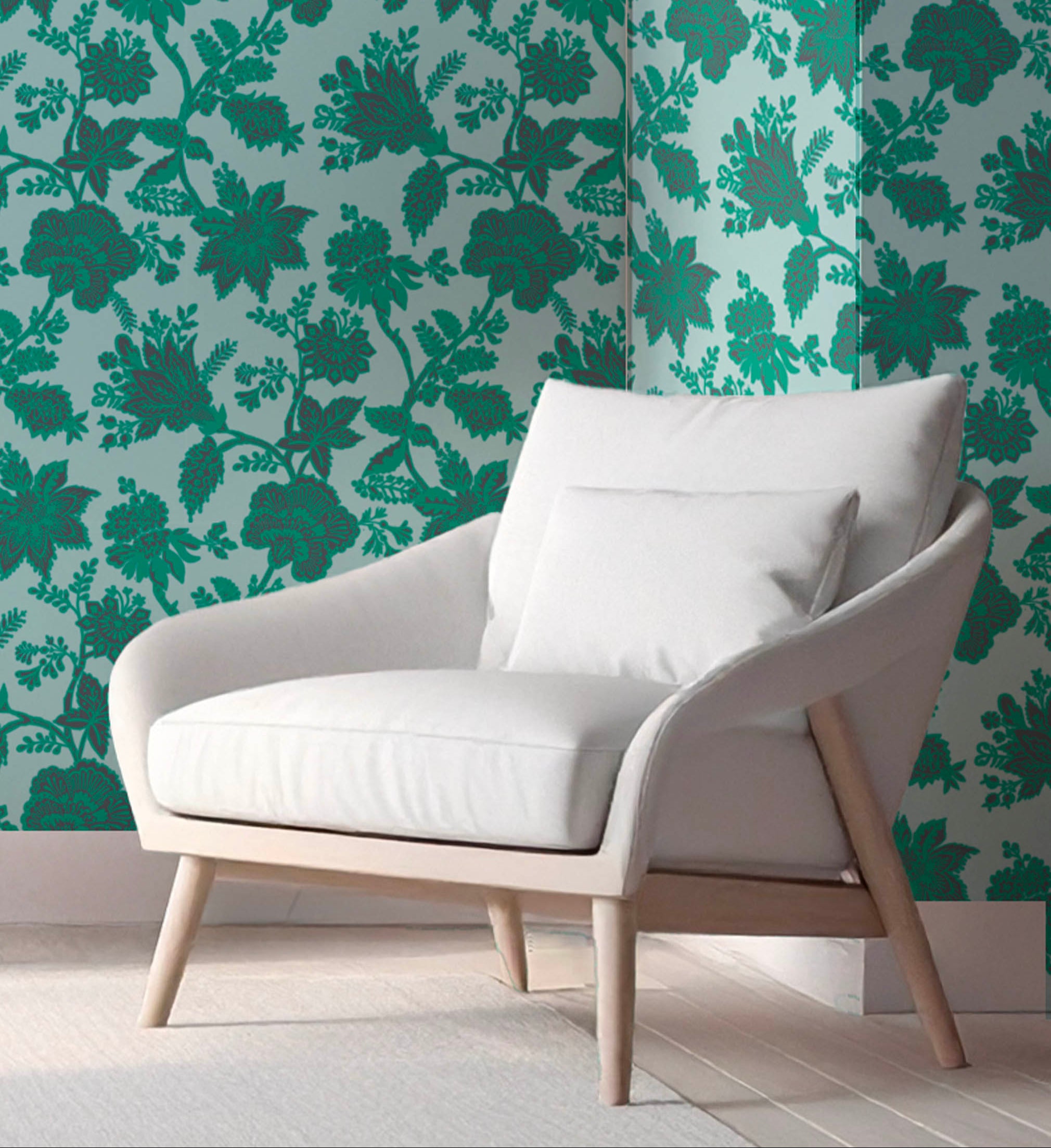 White armchair in front of a wall with holland street green floral patterned wallpaper. Hand-drawn in the London studio.